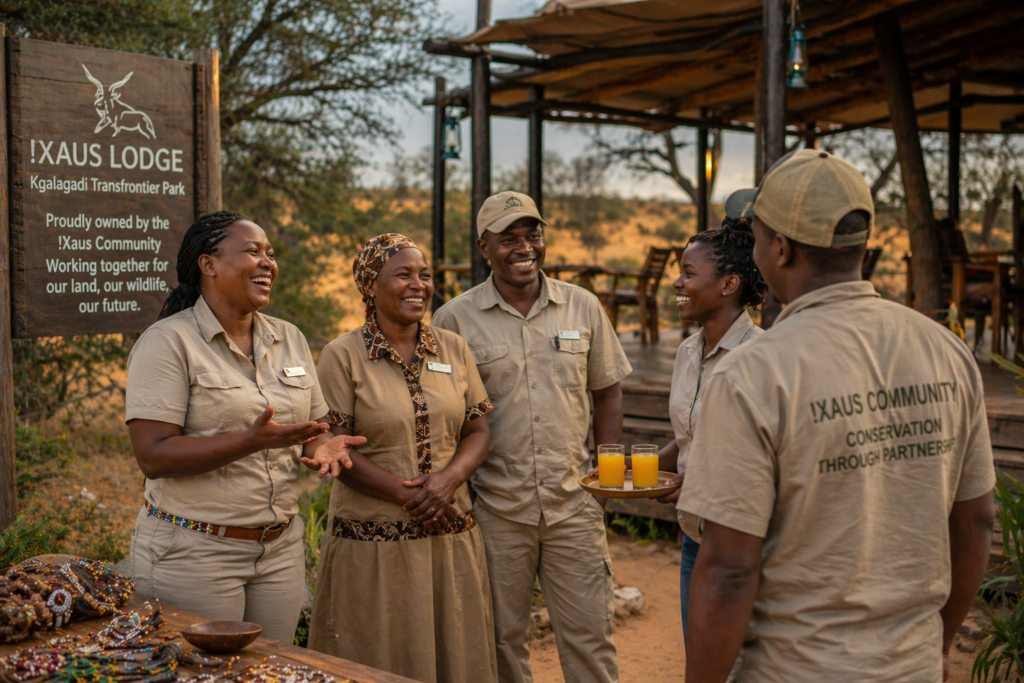 Community-owned safari lodge staff in Africa benefiting from conservation tourism revenue model